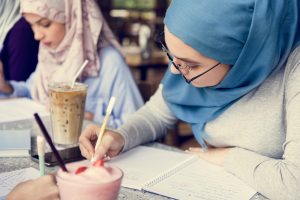 Islamic friends discussing and reading books together