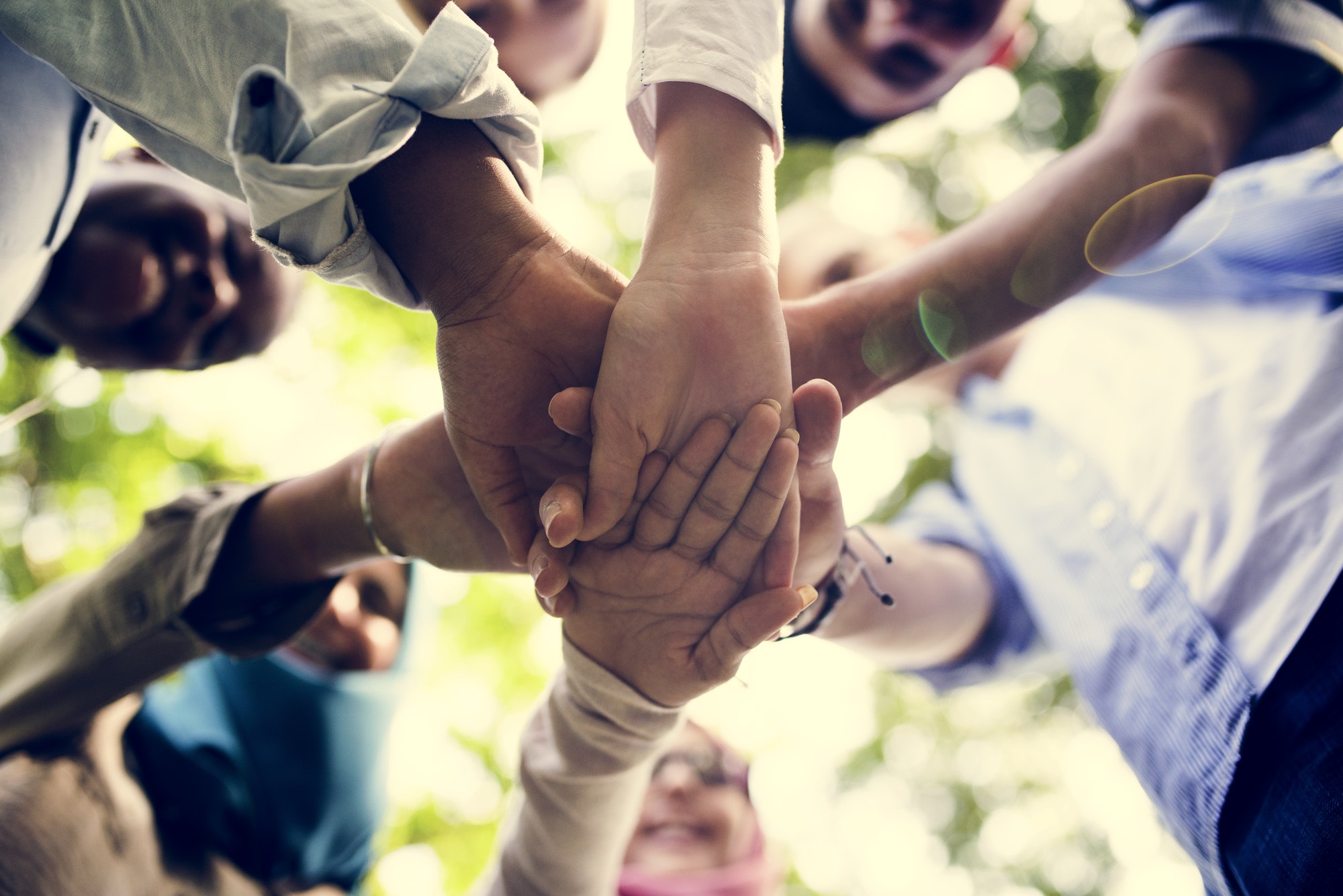 Group of diverse youth with teamwork joined hands